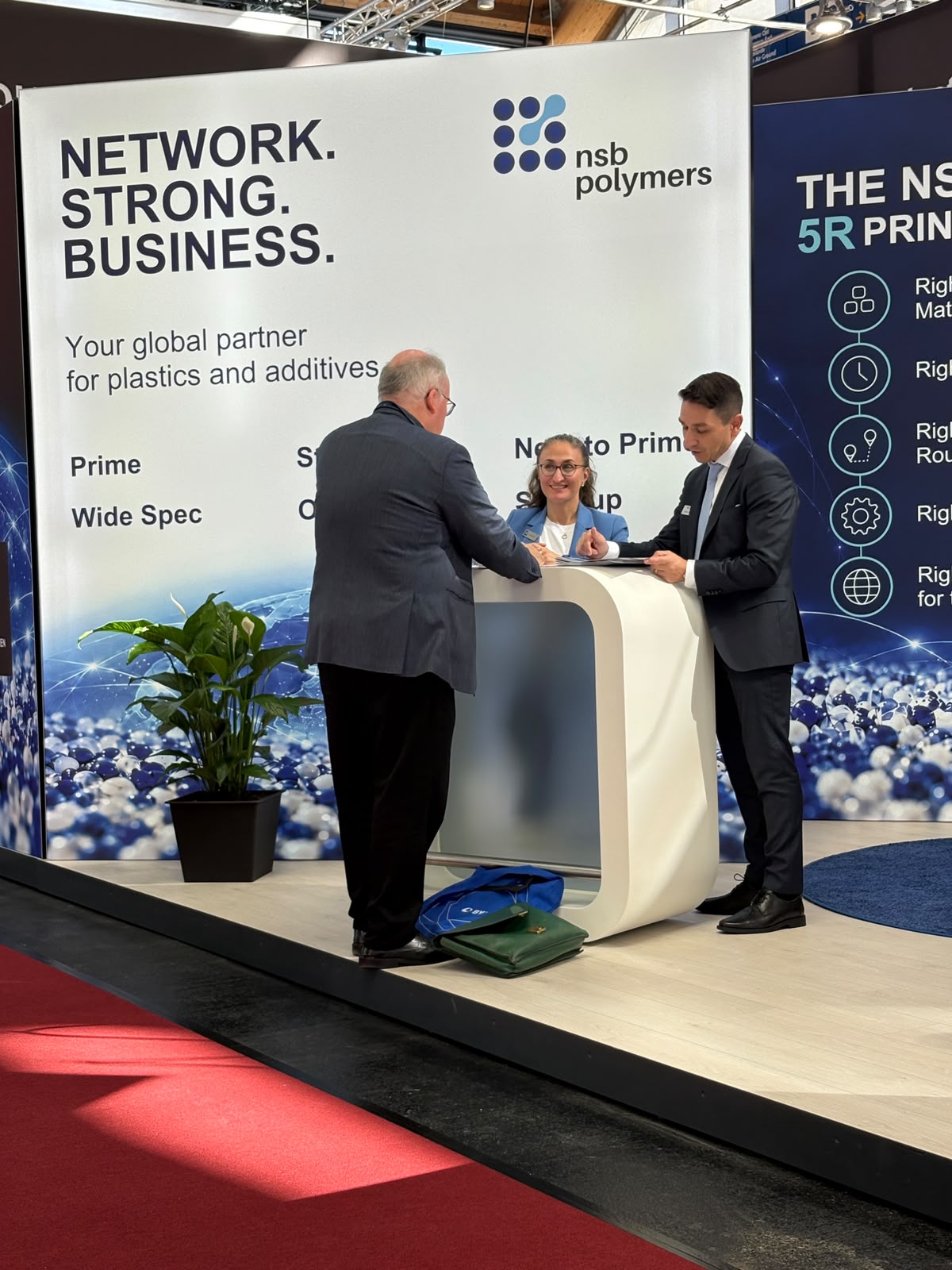 Meetings in front of the materials wall at the NSB Polymers stand, FAKUMA 2026